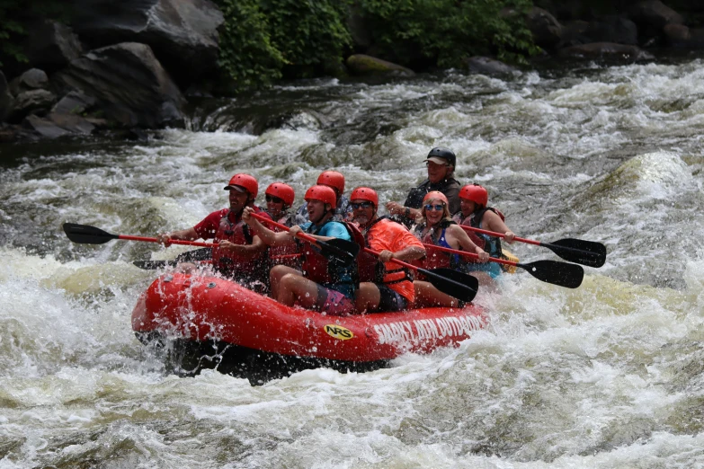 a group of people riding on the backs of rafts
