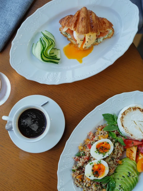 a variety of plates of food on wooden table