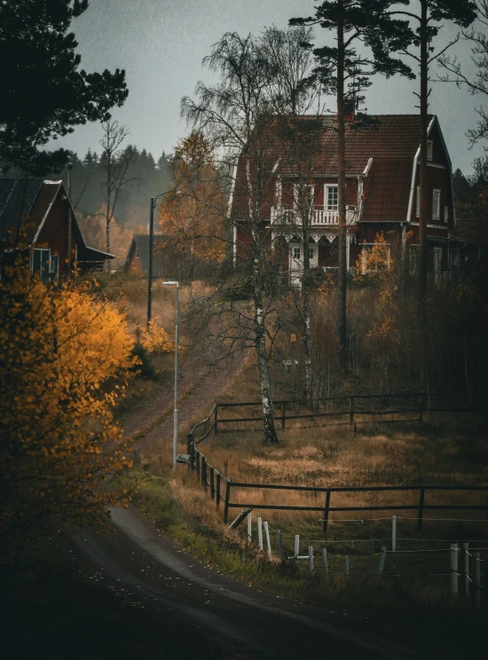 a small road that runs between two large houses