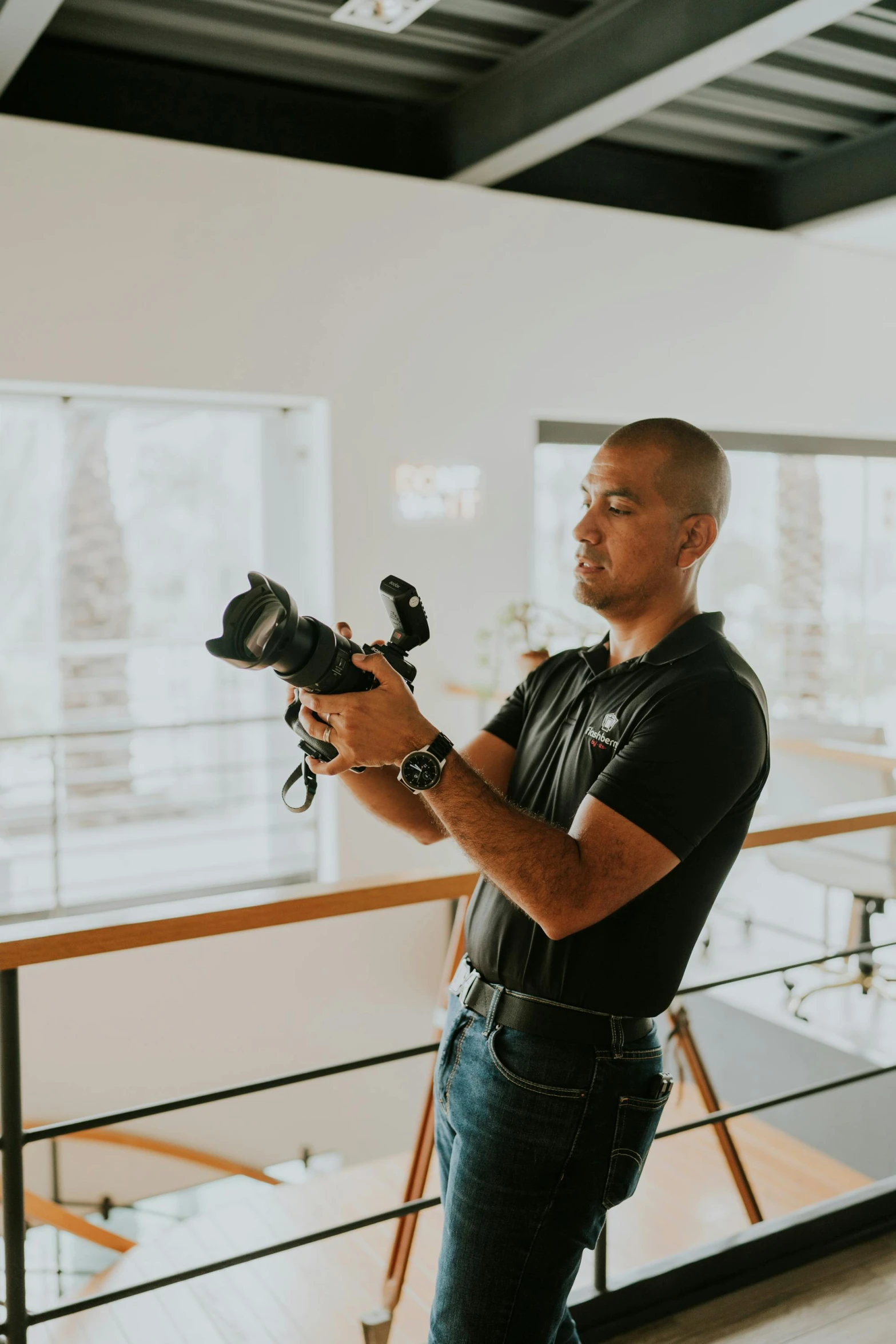 a man holding a camera on his right hand