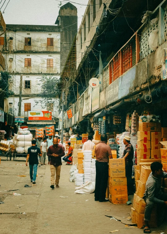 several people walking and standing around a busy street