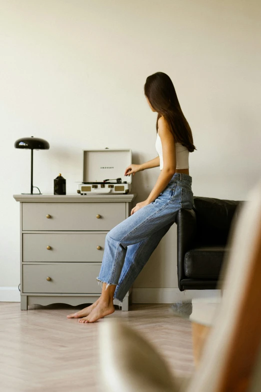 a woman sitting on top of a black couch