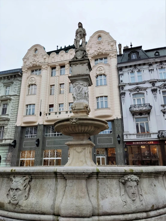 a large building with two stories and a fountain