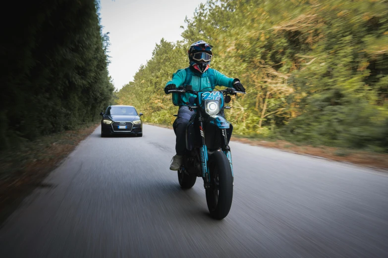 the motorcycle rider is rounding the curve on the road