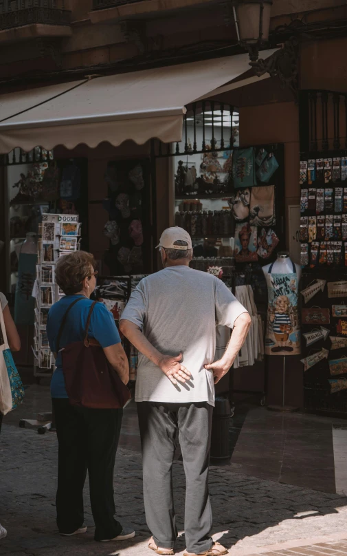 a group of people standing around looking at items for sale