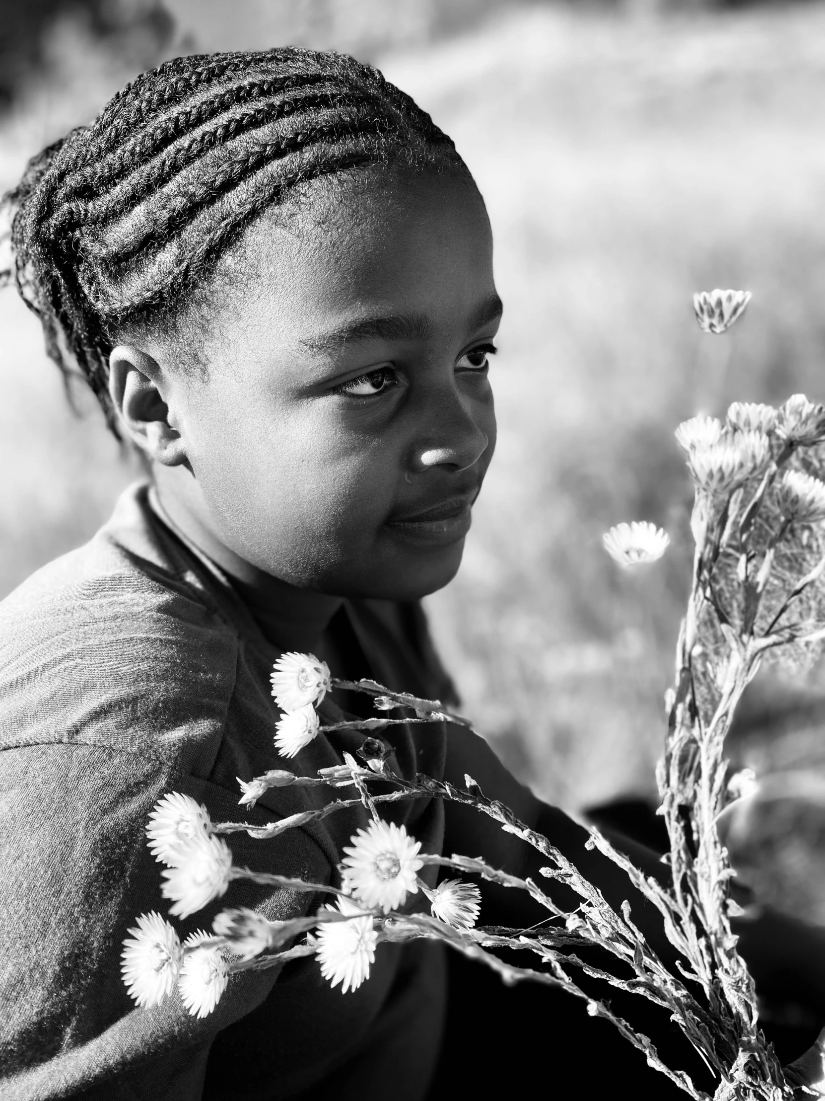 the girl is holding a bunch of flowers in her hands