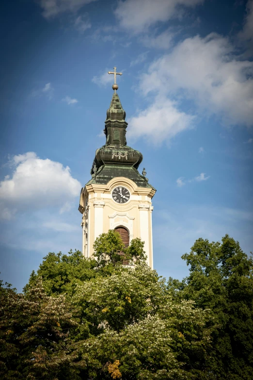 a church tower with a sky background, including clouds