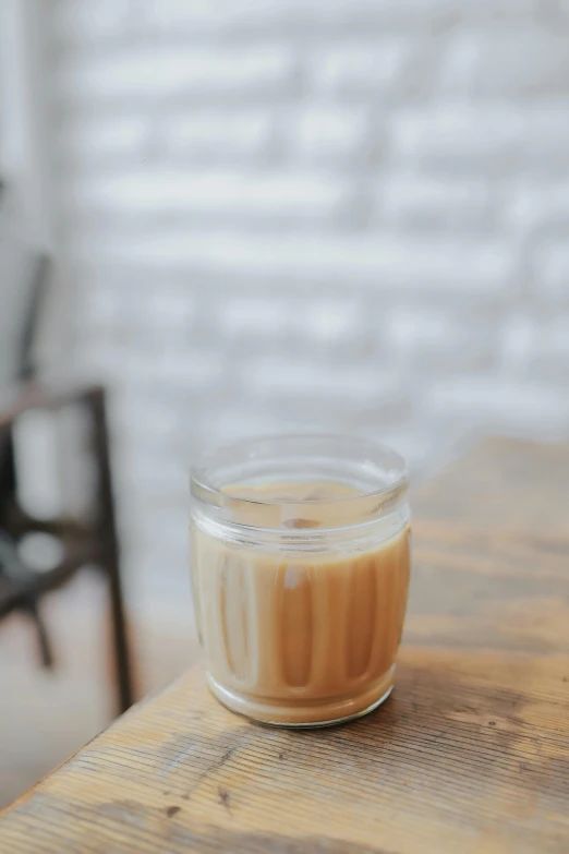 a glass jar that has some liquid in it