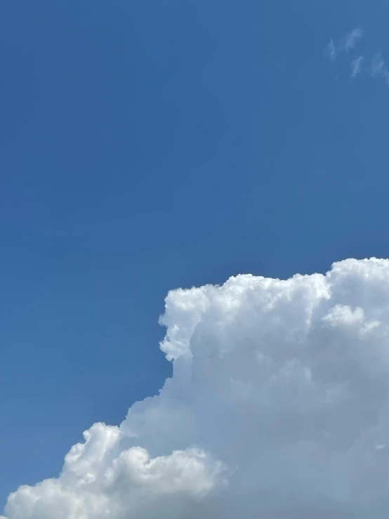 an airplane flying by while the sun shines down