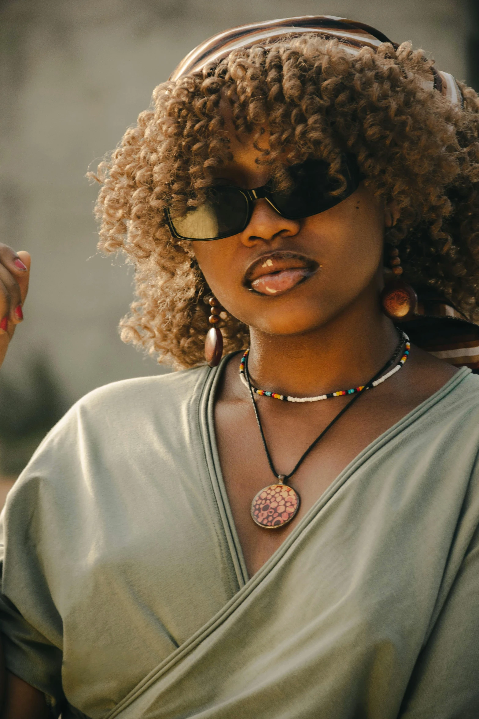 an attractive woman with a large afro has a hand made statement