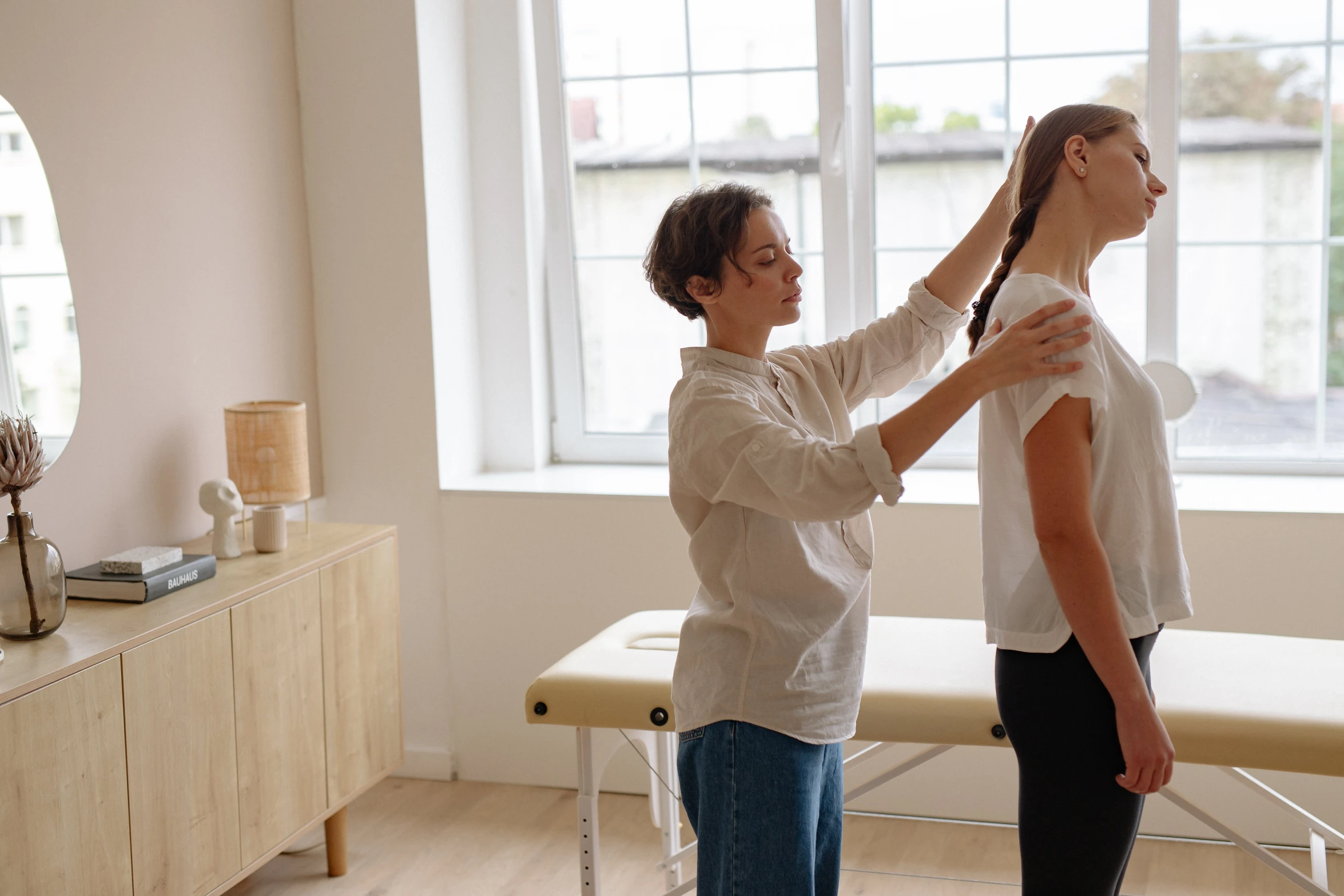 the woman is helping her friend cut her hair