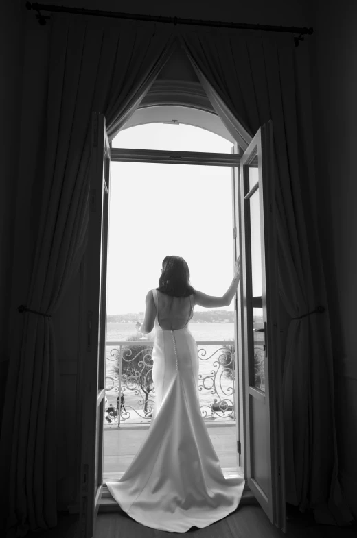 a bride is in the doorway with her hair blowing