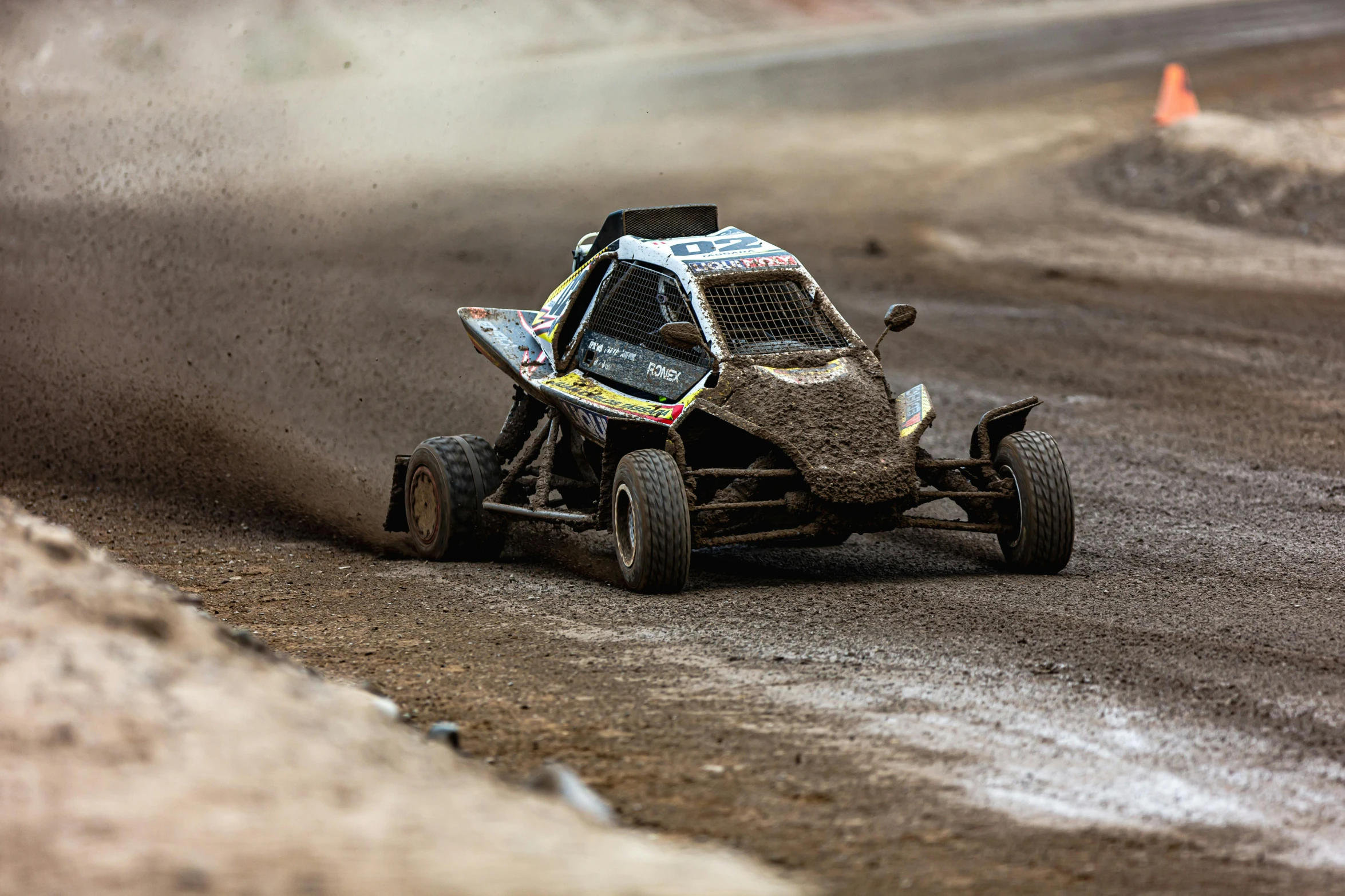 a dirt race car speeding around a corner