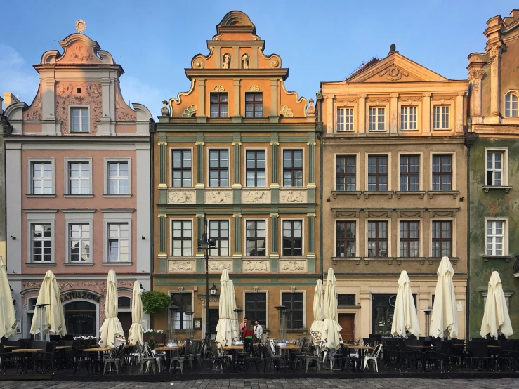 the building facade is tan and has lots of windows