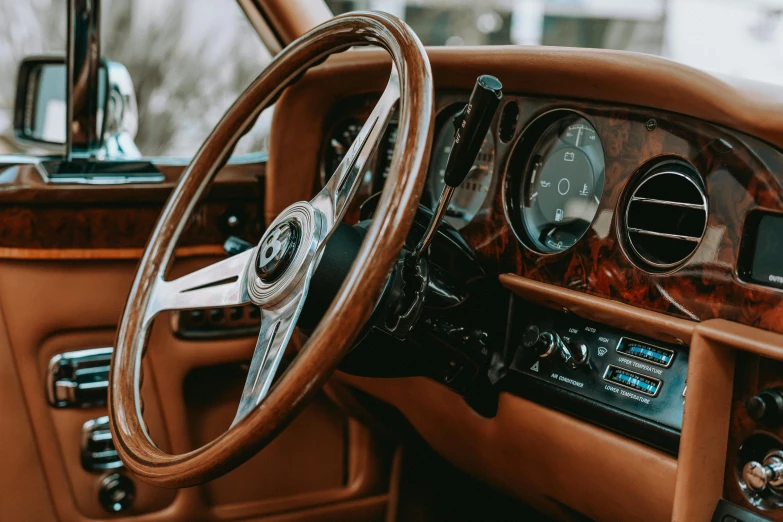 steering wheel of an old car with a dash board