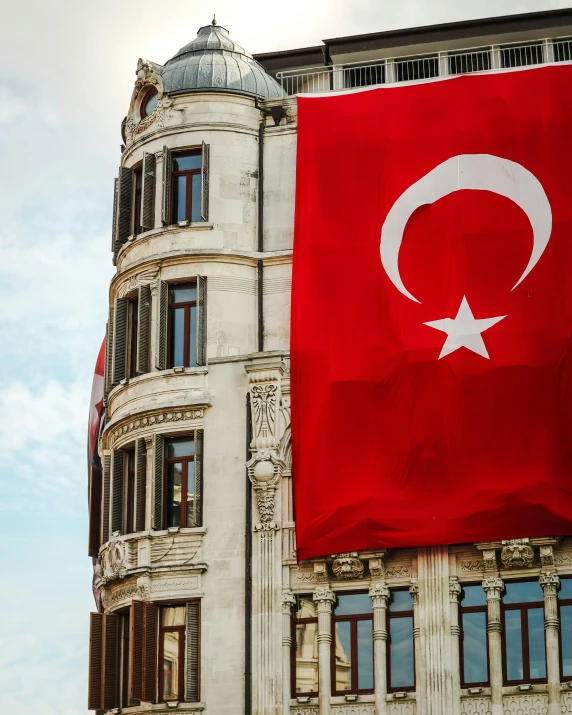 an image of a big turkey flag in front of a building