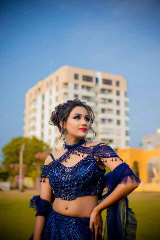 an asian woman in a blue dress posing for a picture