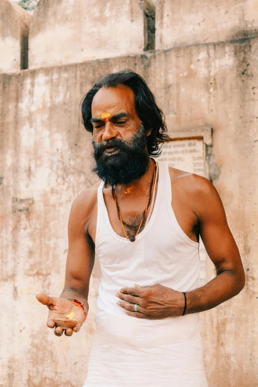 an image of a man in white clothes pointing his finger