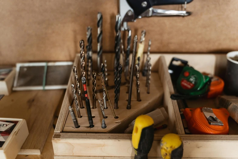 an organized drawer holds drill, drill and drillers