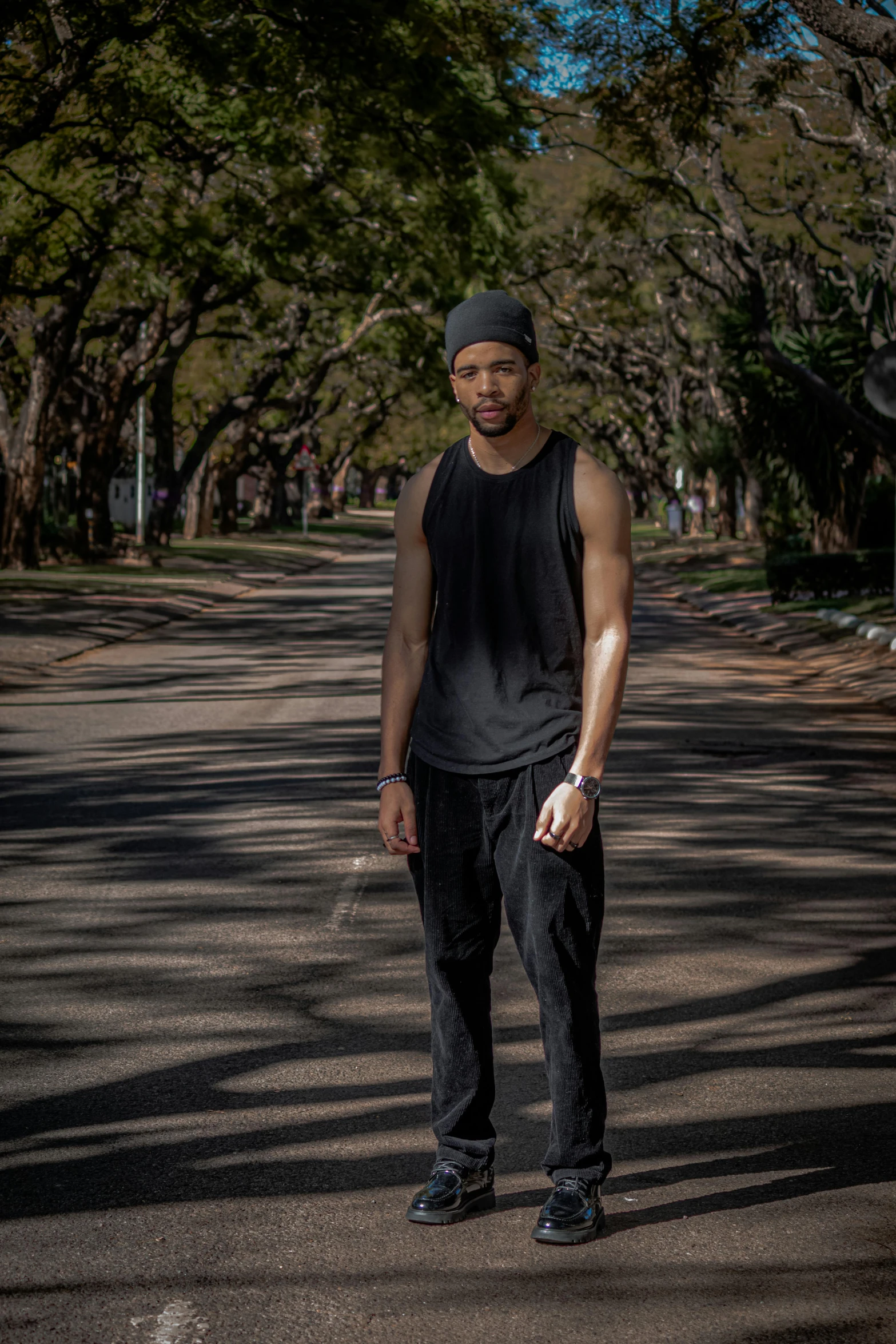 a man stands in the middle of an empty road