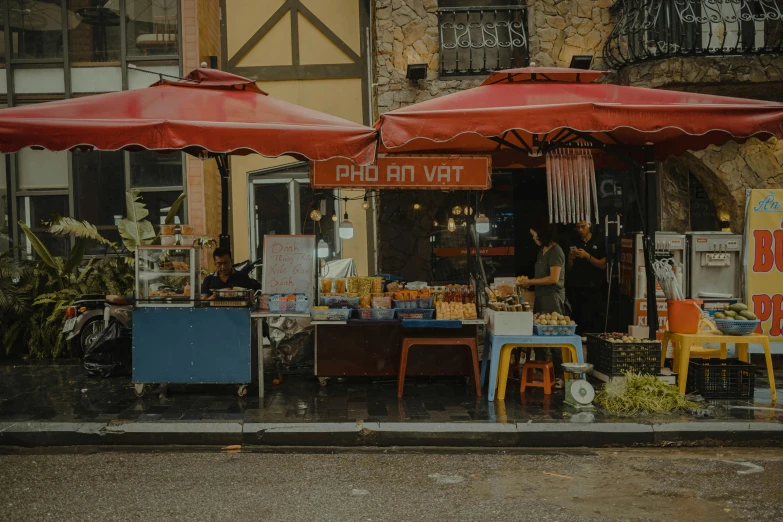 people are outside in the rain outside a store