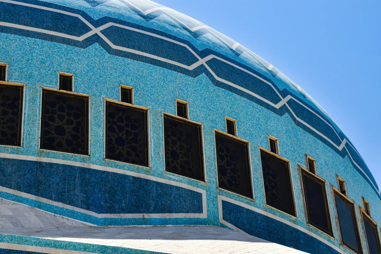 a close up of a blue building with multiple windows