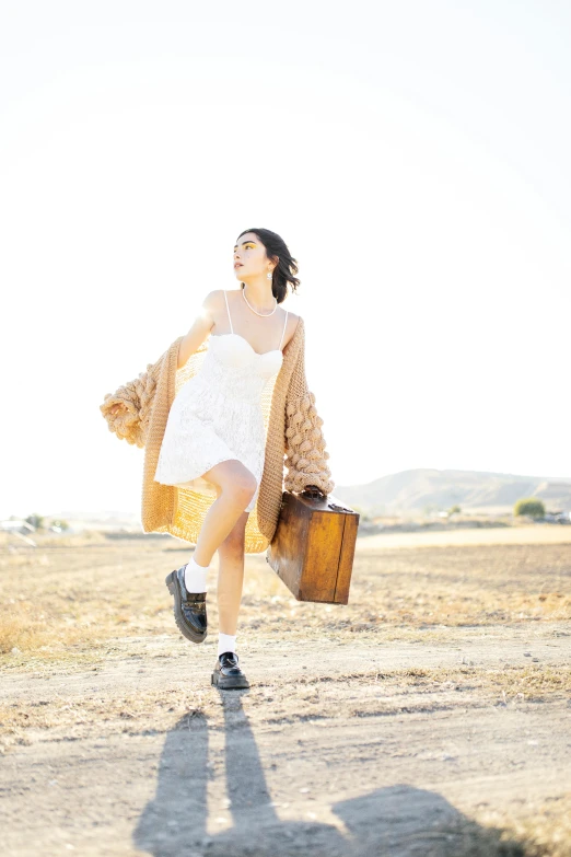 a girl in the field is running and smiling