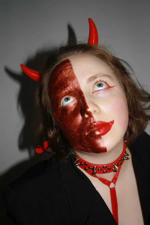 a woman with red painted on her face