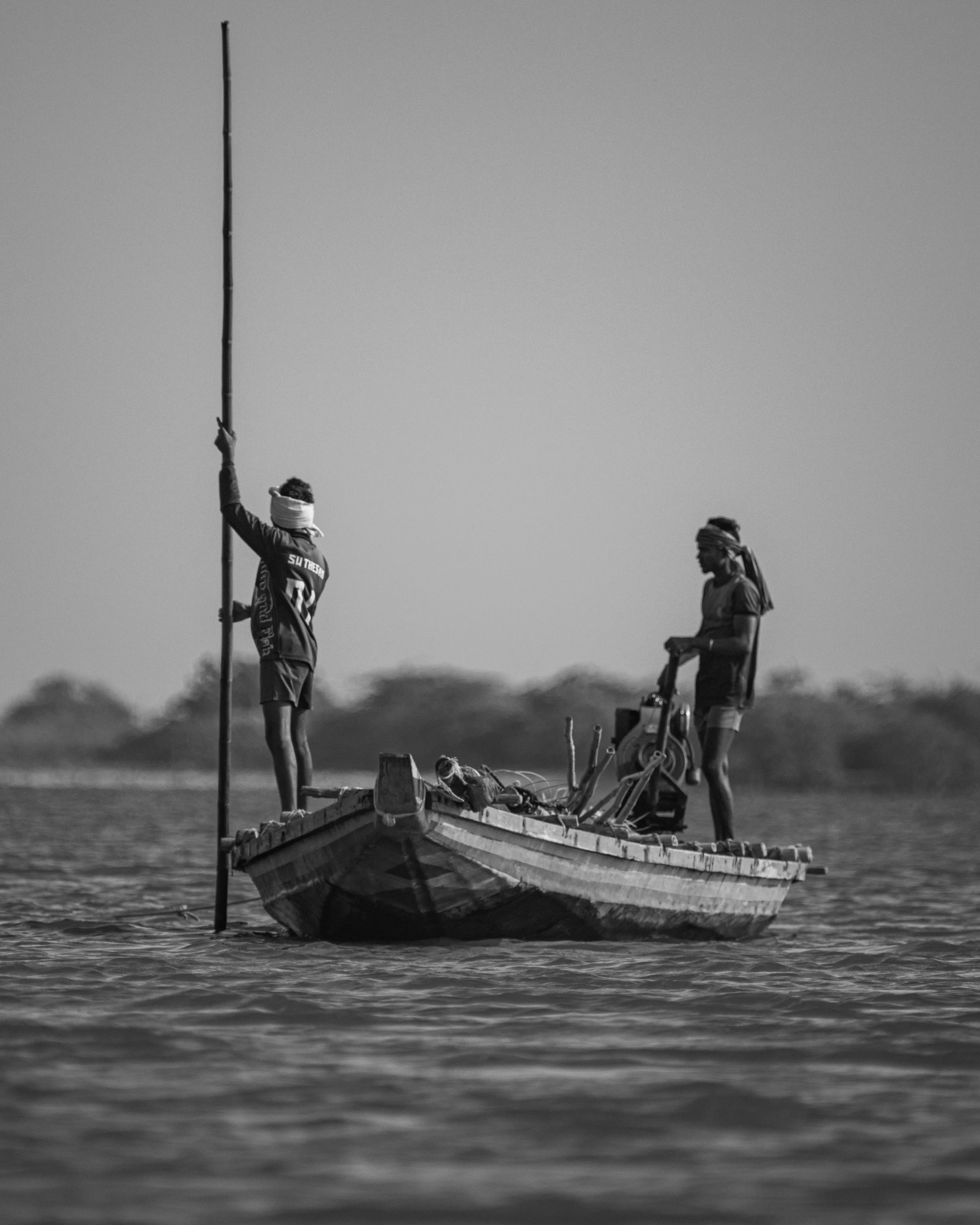 two men on a boat preparing to sail