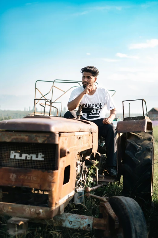 man sitting in an old tractor on the farm