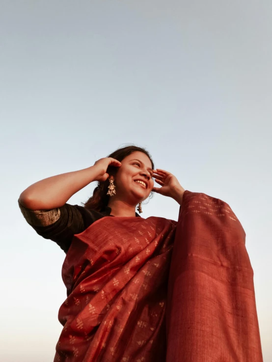 a woman in a red sari poses for the camera