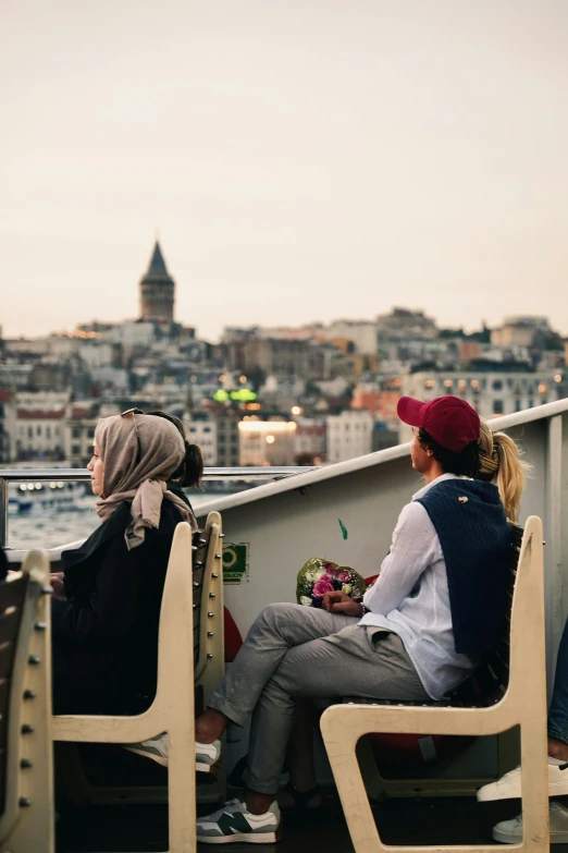 two people sitting on the roof enjoying some water