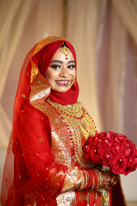 a young woman in an elaborate bridal dress holding a bouquet