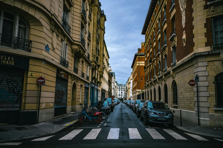 the view down a city street where cars are parked