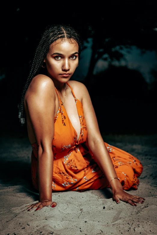 a woman in a yellow dress is sitting and looking away