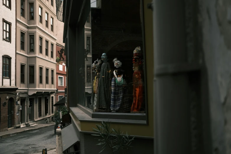 mannequins in the window with windows decorated all around