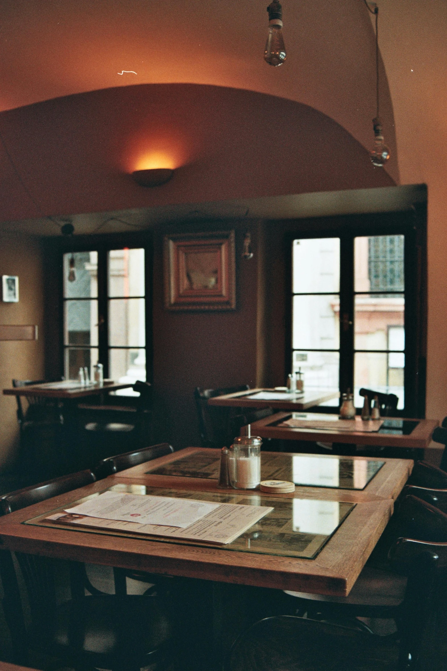 there is a wooden table with a glass on top