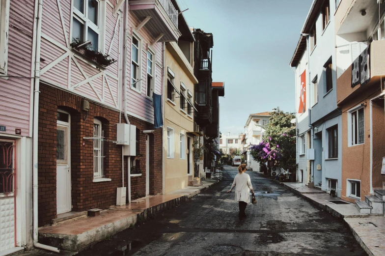 a person that is walking down a street