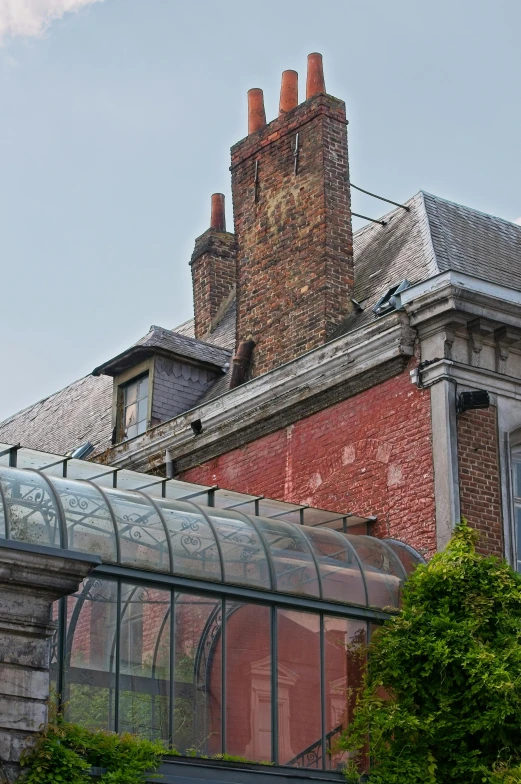 the view of a building with a brick chimney and roof