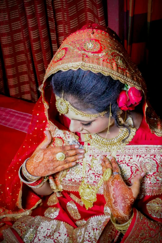 a beautiful young lady wearing a traditional bridal dress