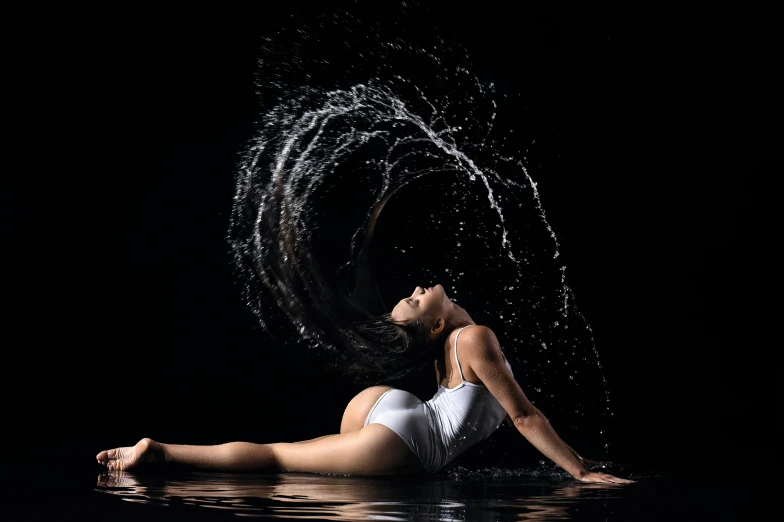 an artistic pograph of a young woman sitting in the water