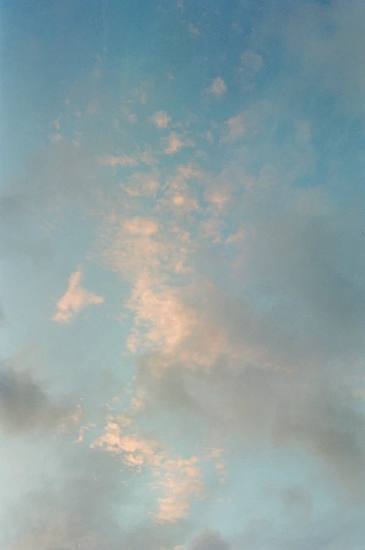 a plane flying in the sky with clouds