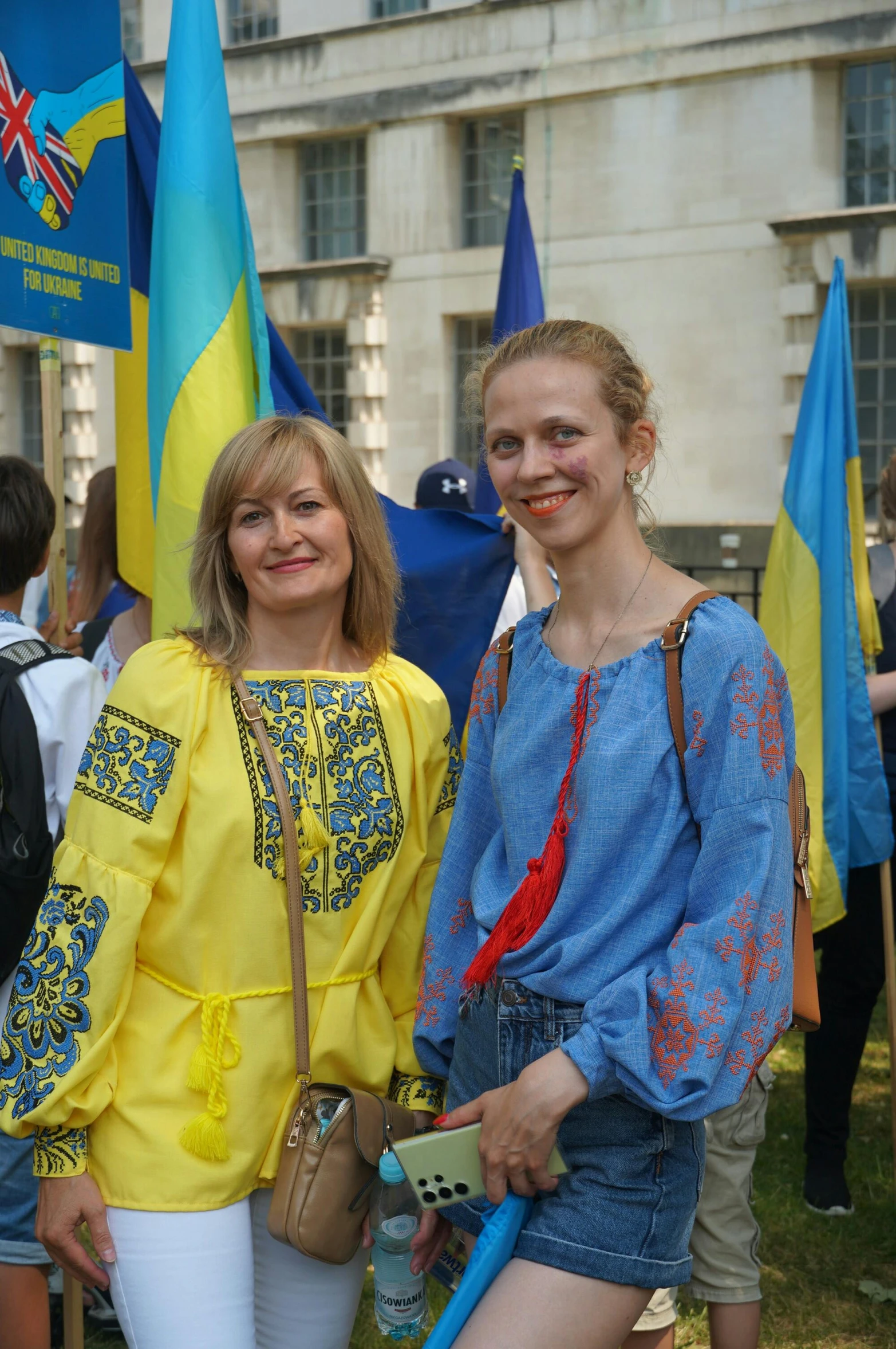 two women are standing in front of flags