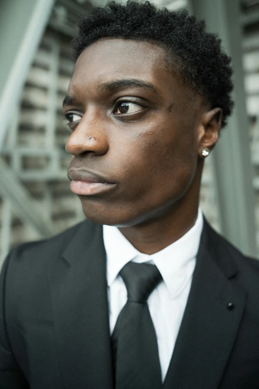 a man wearing a suit with a tie around his neck