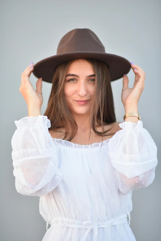 a woman in a hat with long brown hair