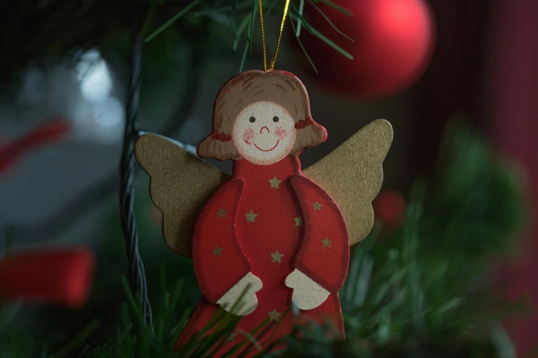 a wooden ornament hanging on a christmas tree