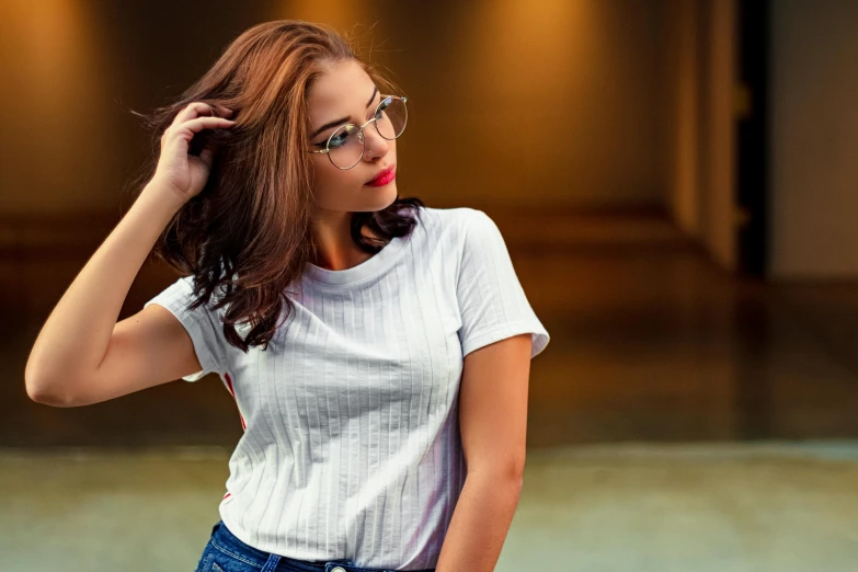 a woman in a white shirt and blue jeans standing