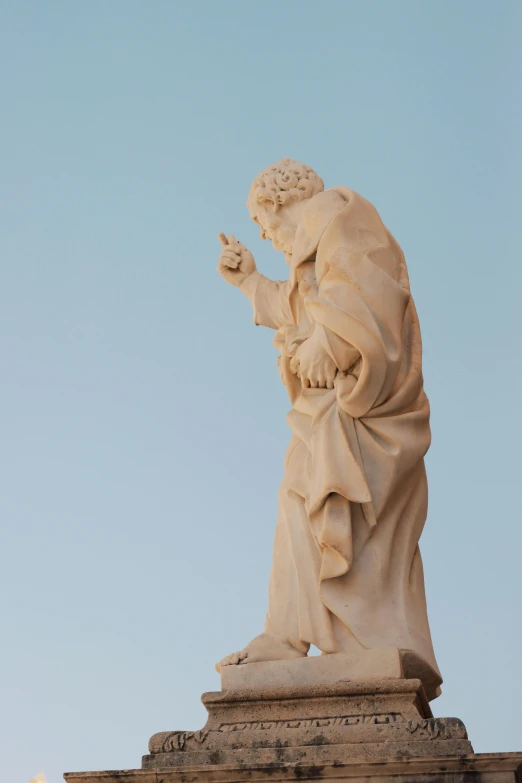 the statue of st peter appears to be praying