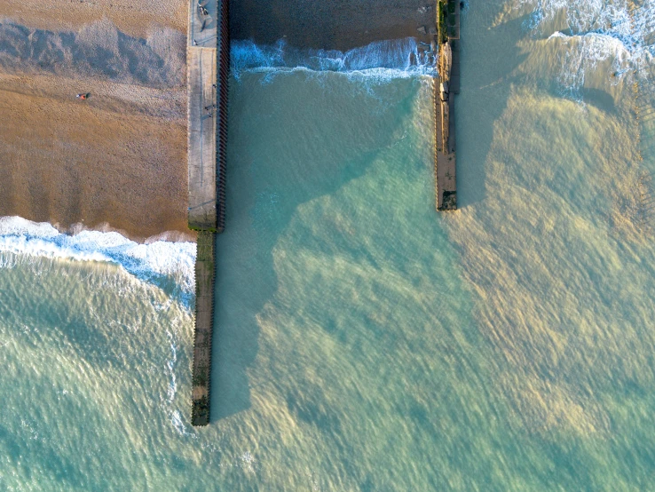 a long pier sitting on the edge of a body of water