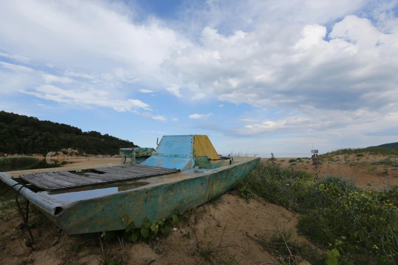 a dilapidated old boat sits on a beach